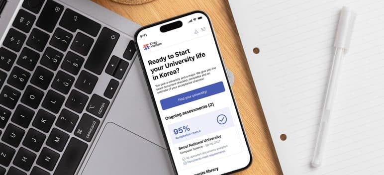 The K-tag app open on a phone beside a keyboard