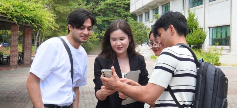 Students looking at a phone together