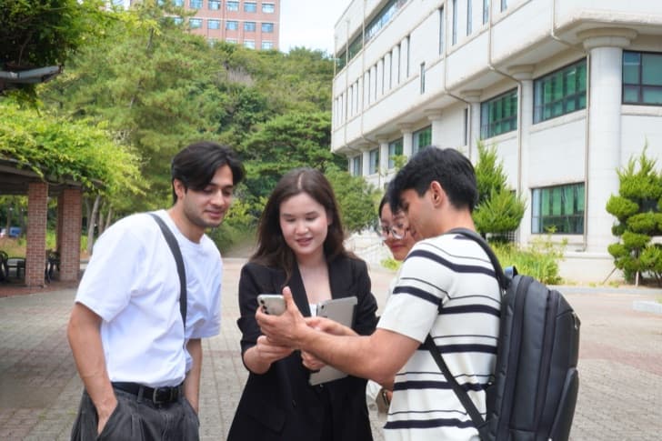 Students looking at a phone together